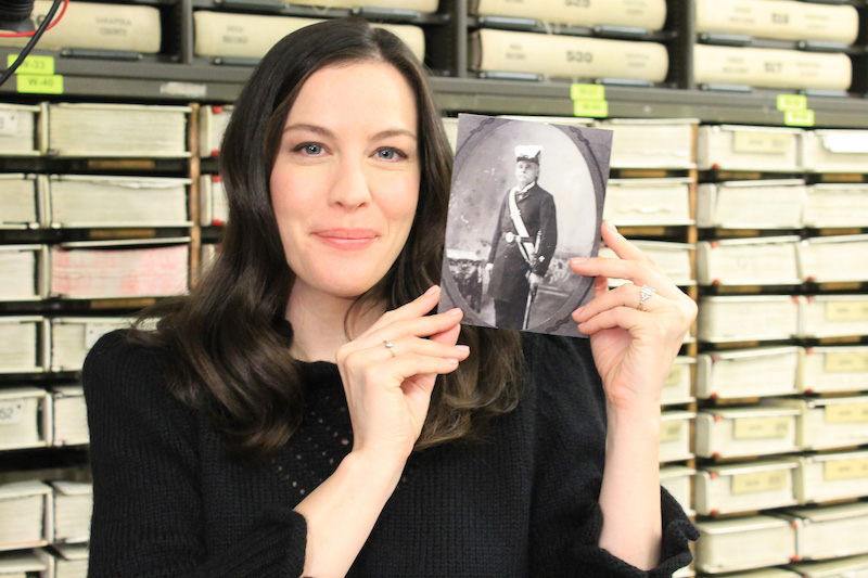 Holding a photo of her great-great-great-grandfather - George Washington Elliott